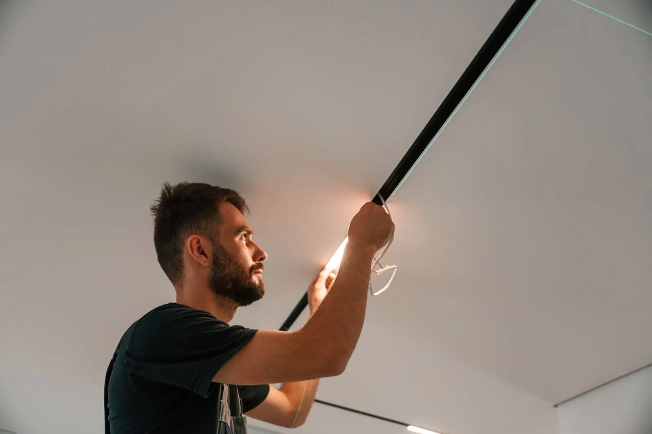 Electrician working on a lighting fixture