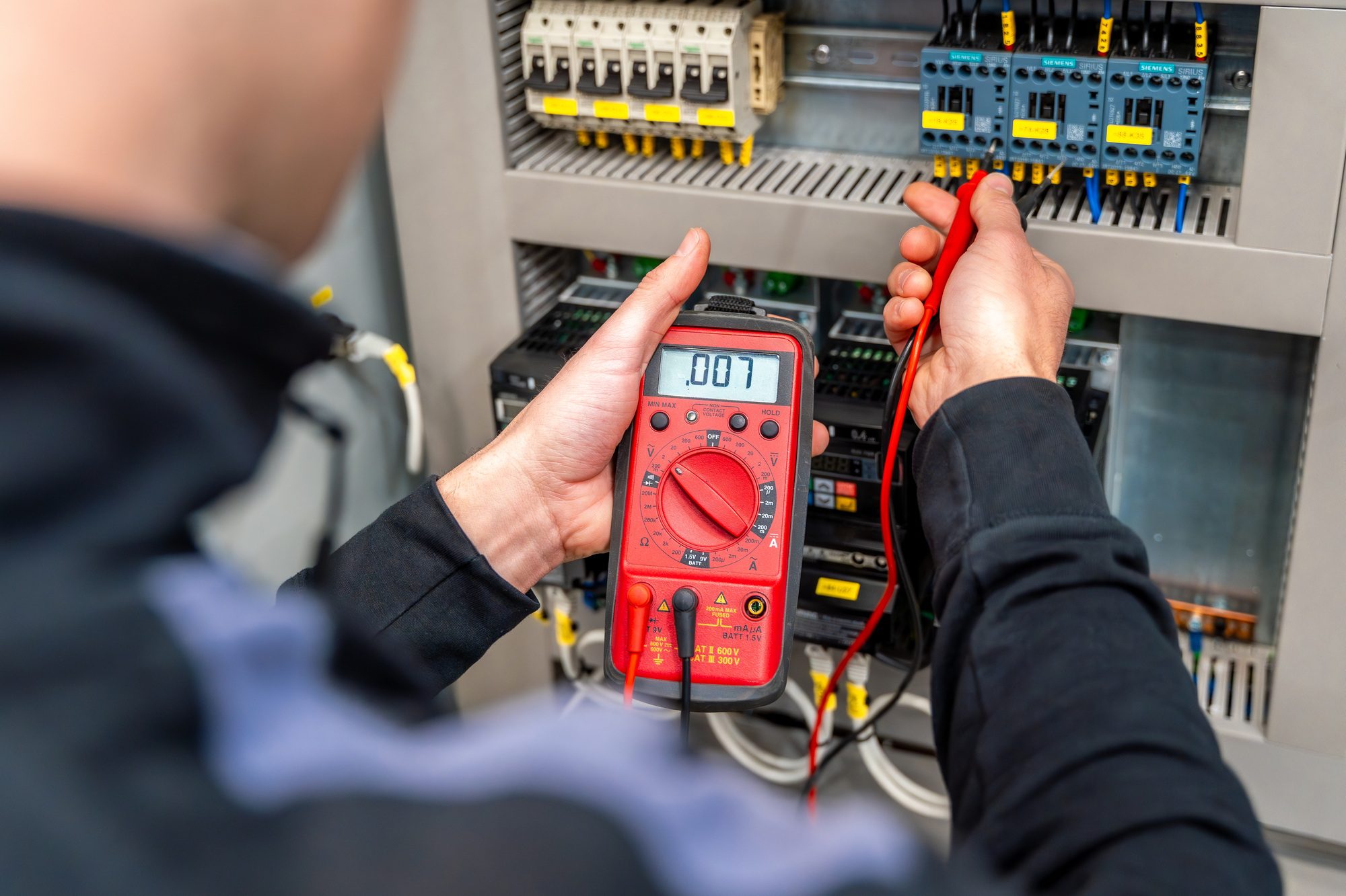 Worker Measuring Electrical Panel